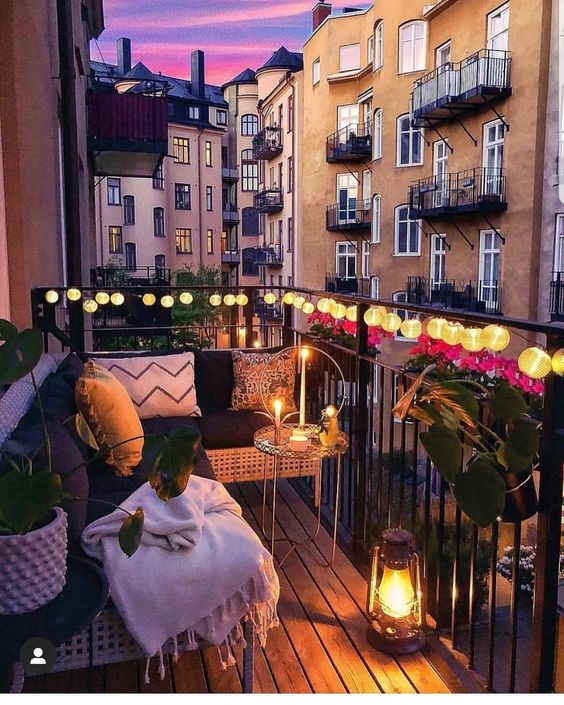 Use of lighting and candles to create warm ambiance in balcony